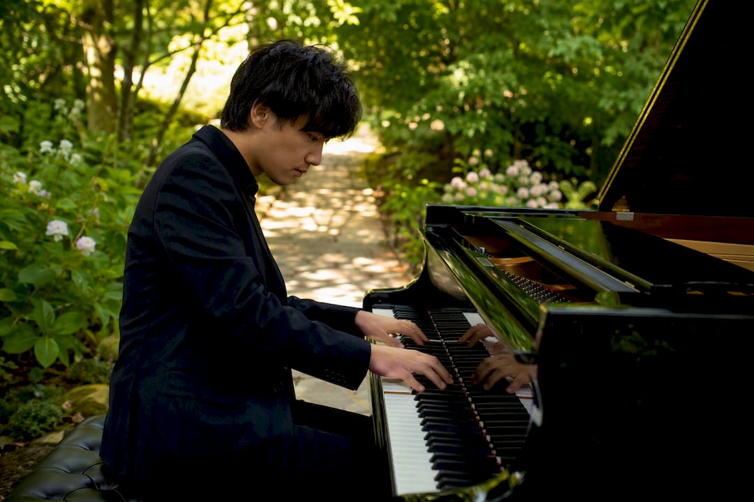 Pianist playing piano in warm studio