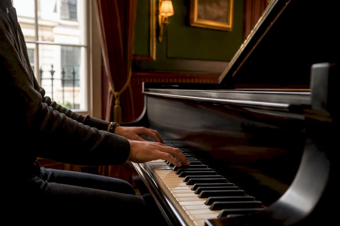 Hands playing piano chord progression