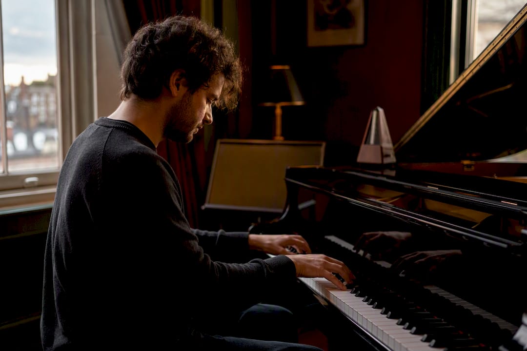 Pianist playing jazz piano in warm studio