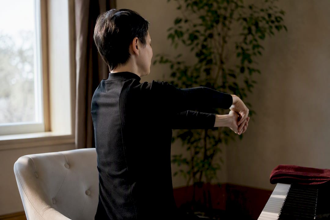 Pianist stretching wrist during practice break