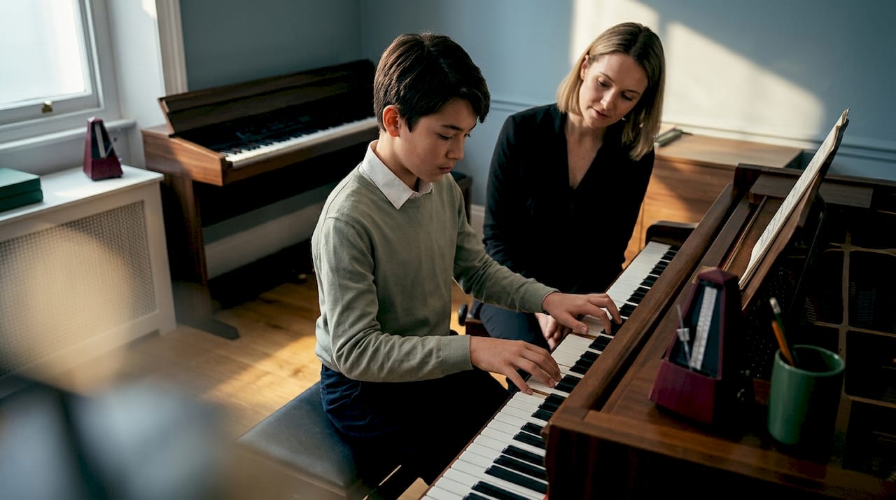 Teacher and student during piano lesson