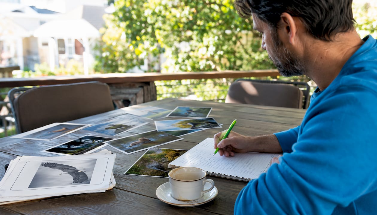 Overhead view of wildlife photo contest materials on desk