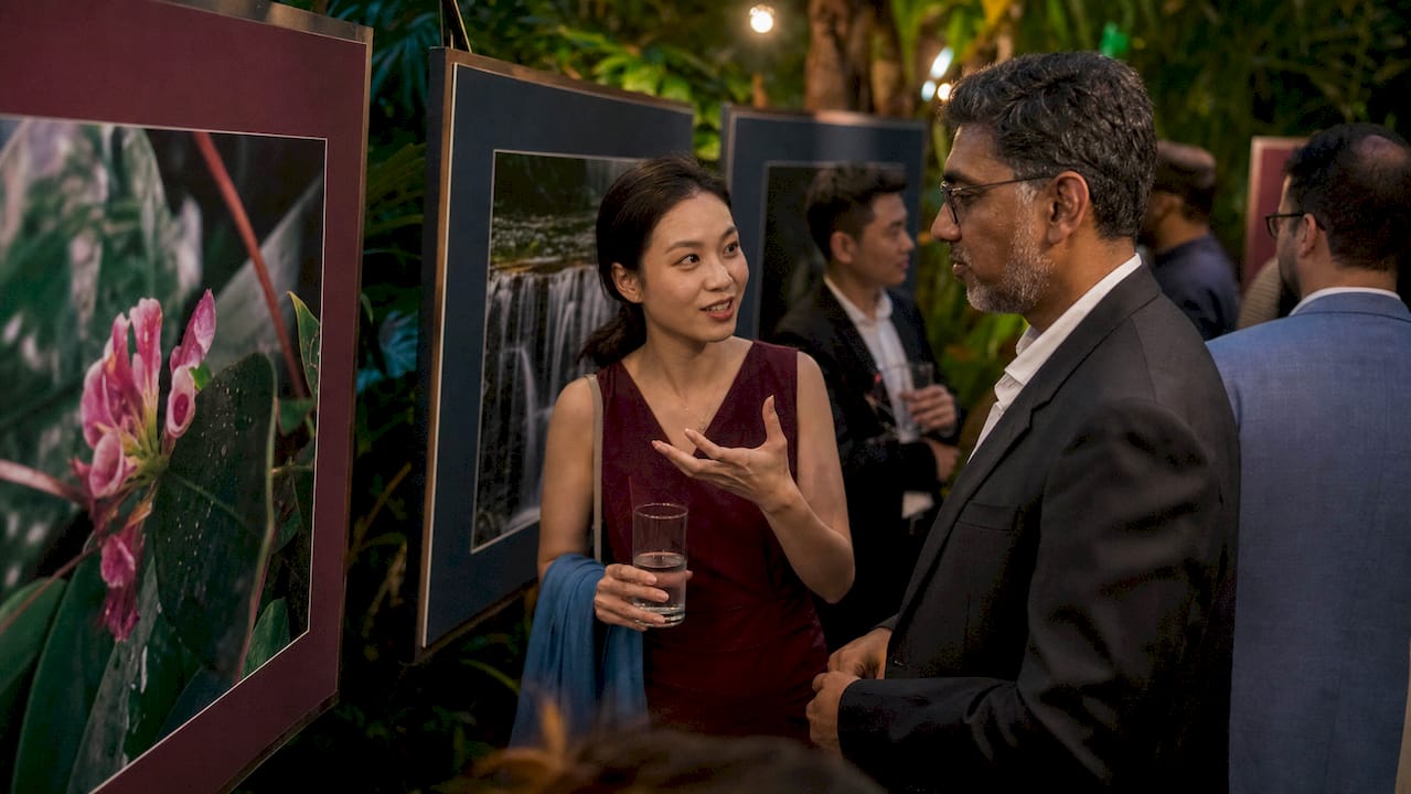 Award ceremony attendees viewing nature photos in gallery