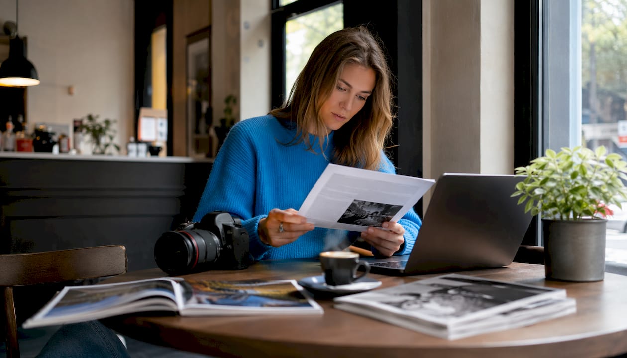Photographer reading Canon contest rules at desk