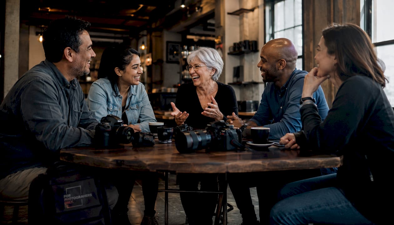 Group of photographers networking at gallery event