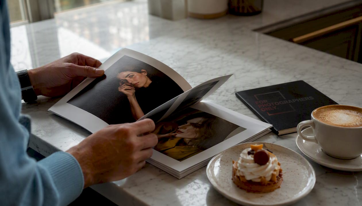 Hands flipping through printed portrait photo series