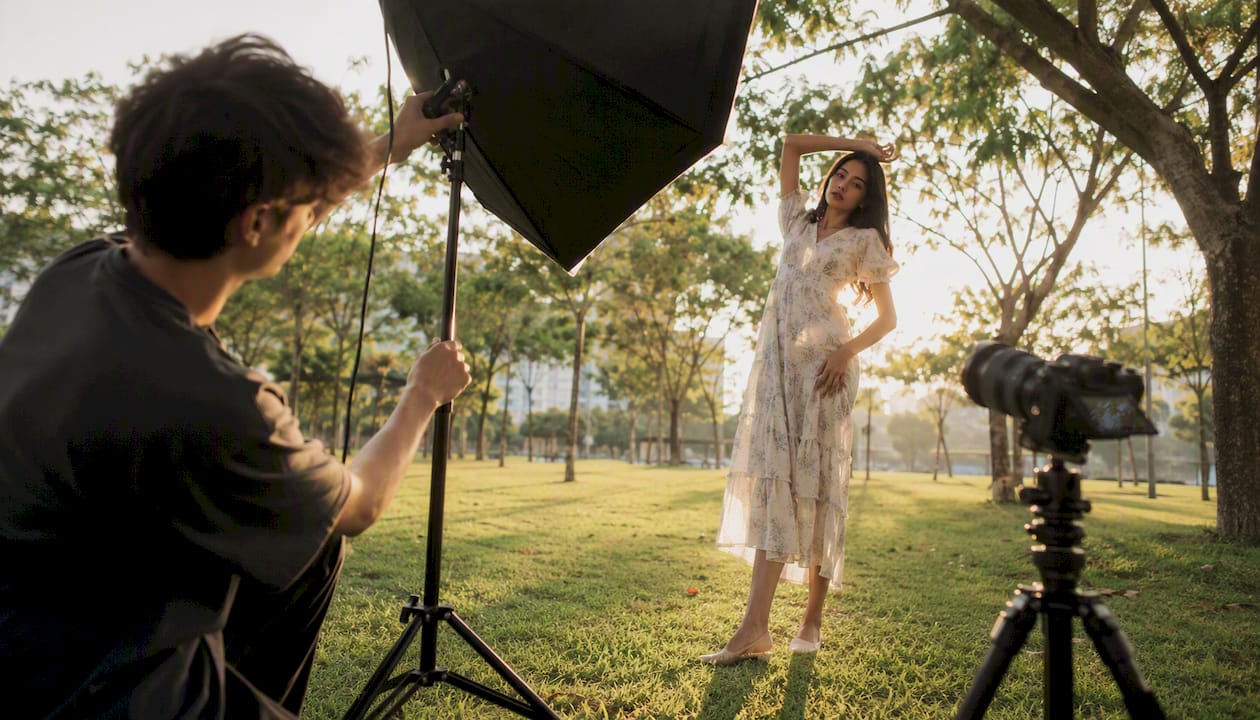 Photographer adjusting lighting on fashion runway shoot