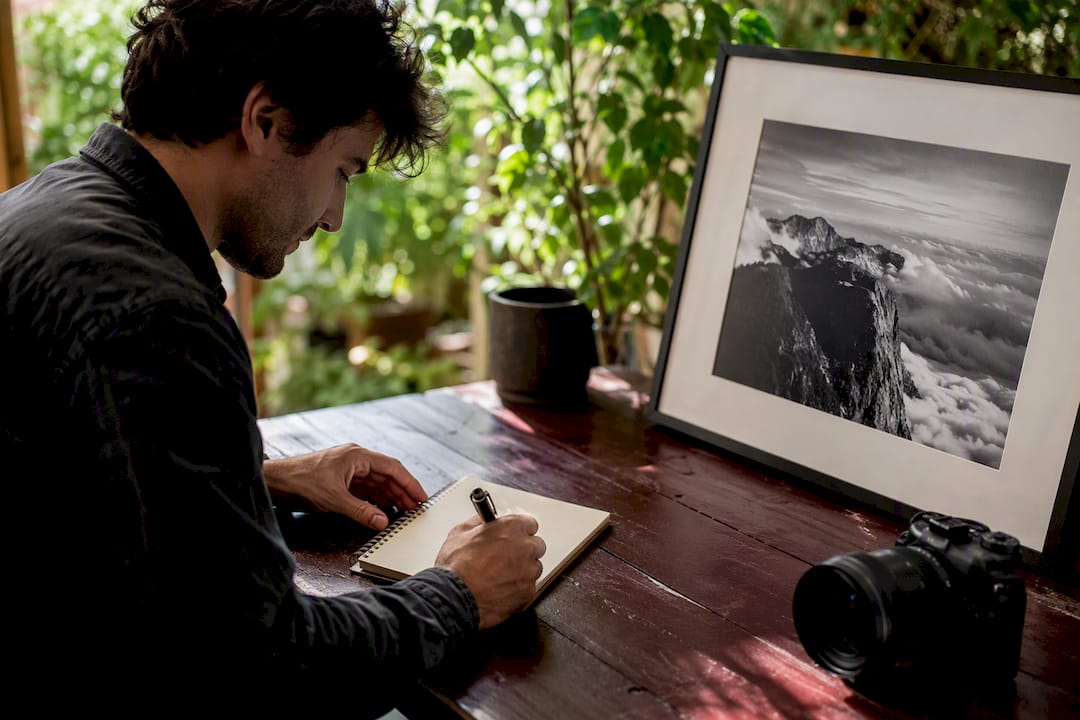 Photographer writing photo caption at desk