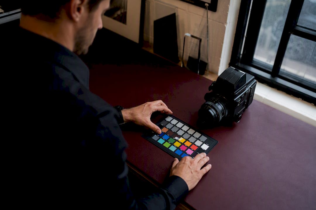 Photographer adjusting color calibration and camera controls