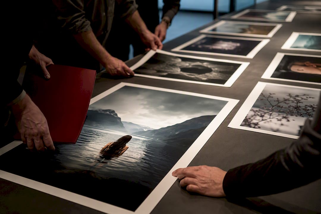 Jury reviewing emerging photographer prints