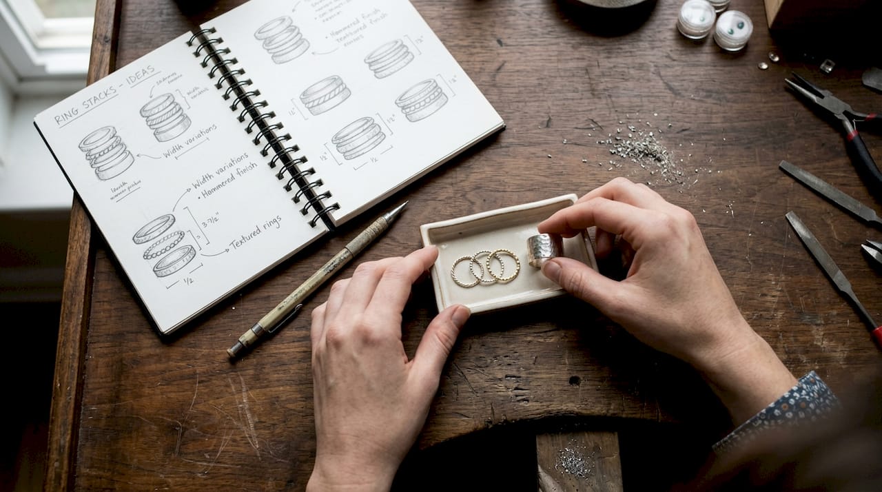 Hands arranging rings of various widths