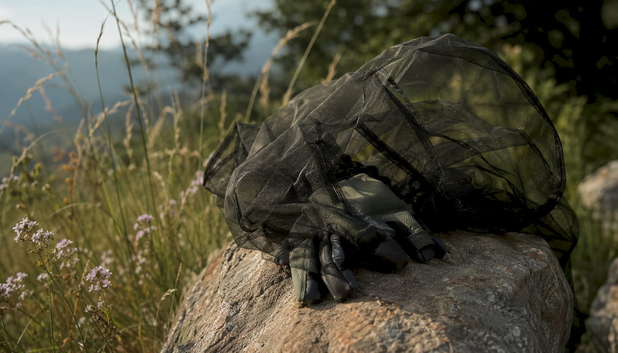 Close-up of ultra-fine mosquito net on gloves outdoors