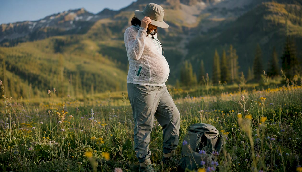 Pregnant woman in forest wearing chemical-free tick protective clothing
