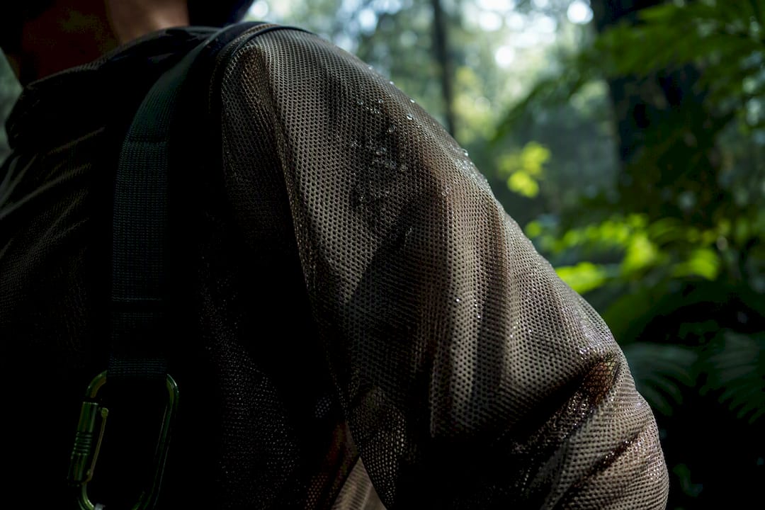 Hiker wearing mesh clothing in humid forest