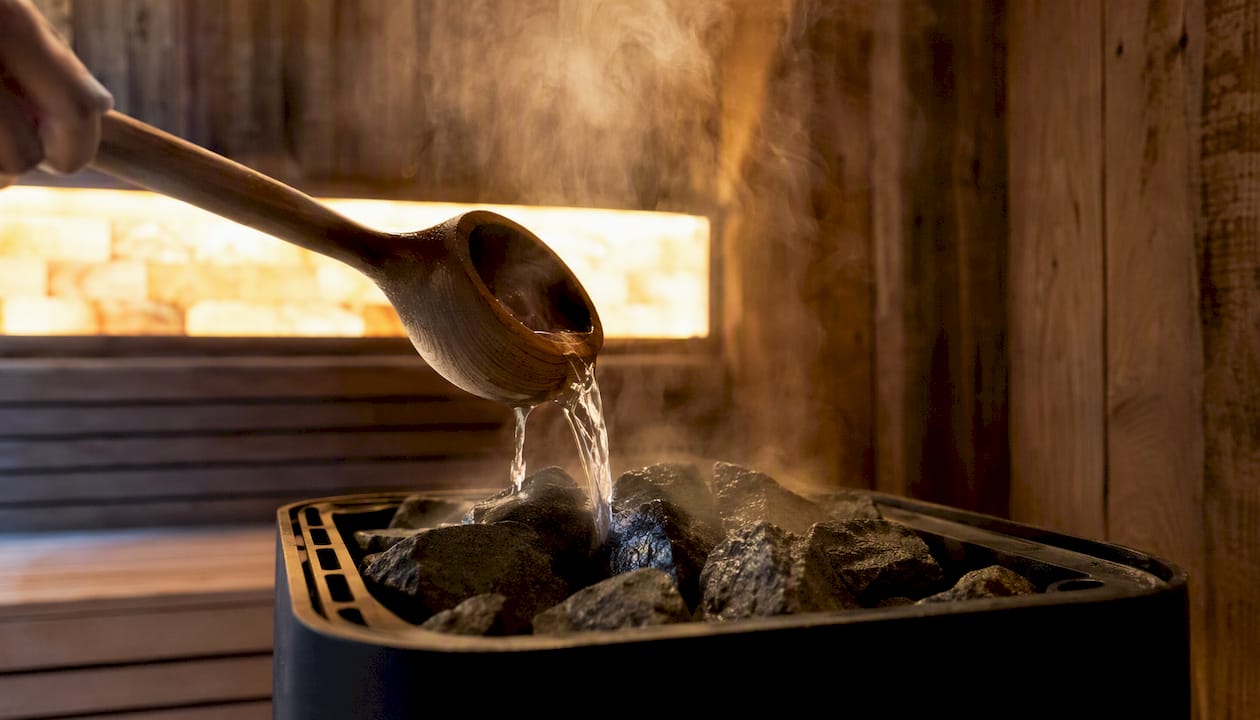 Pouring water over sauna stones