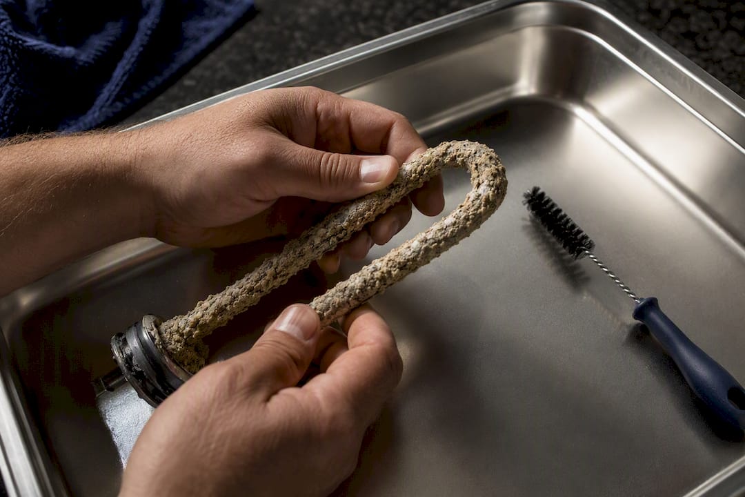Mineral scale coating a heating element