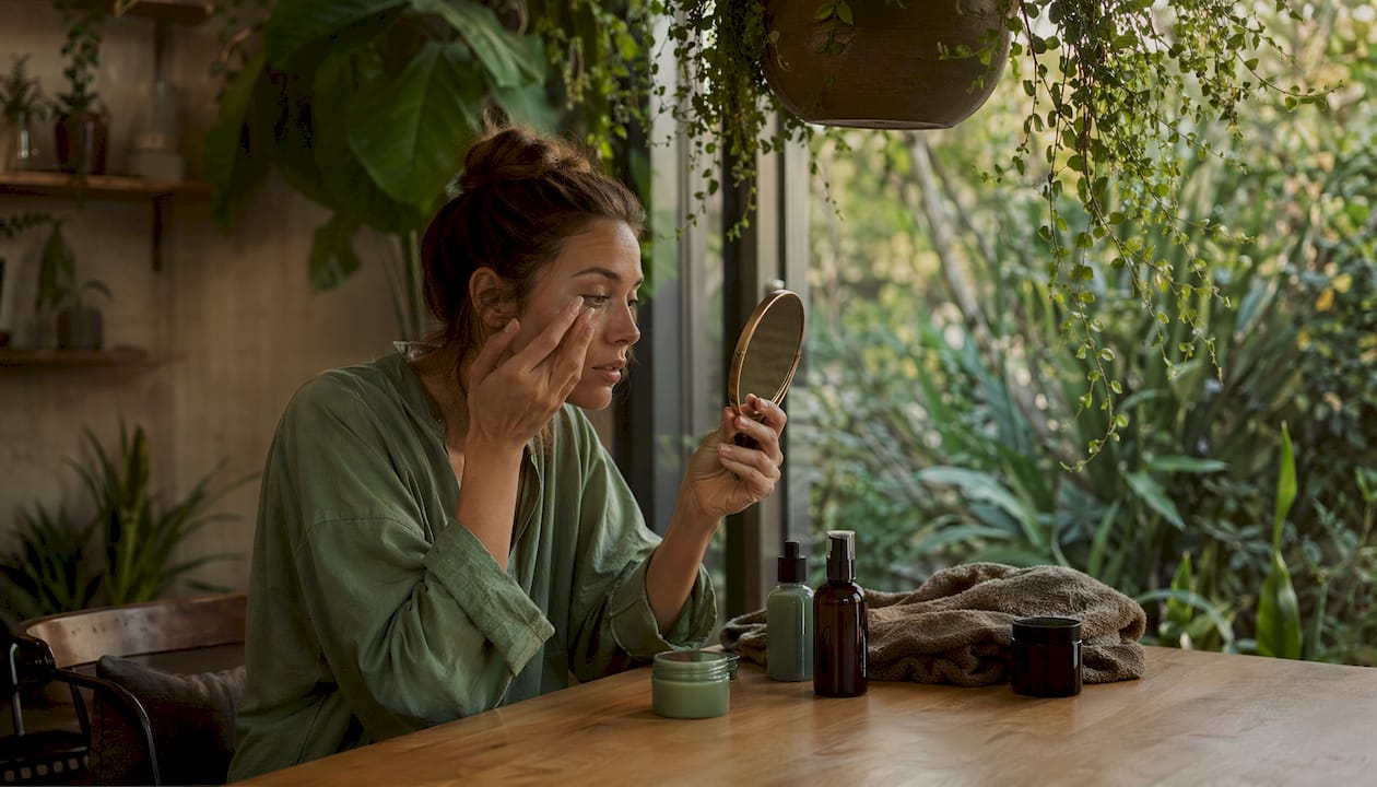 Woman applying eye cream to reduce dark circles