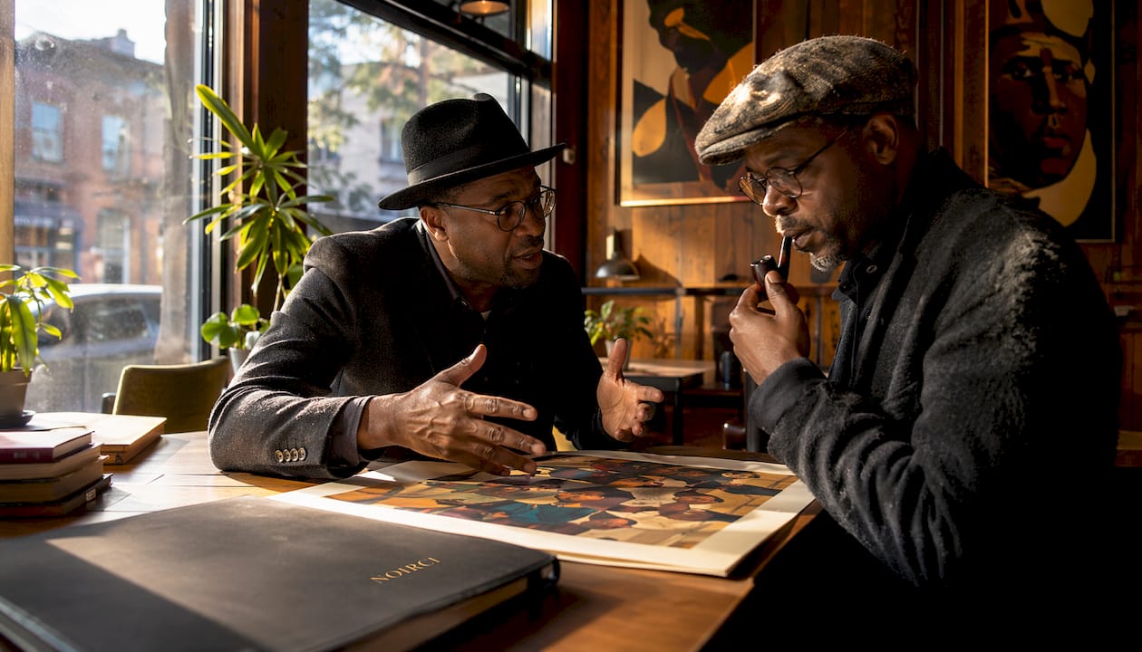 Two men discussing Harlem Renaissance art