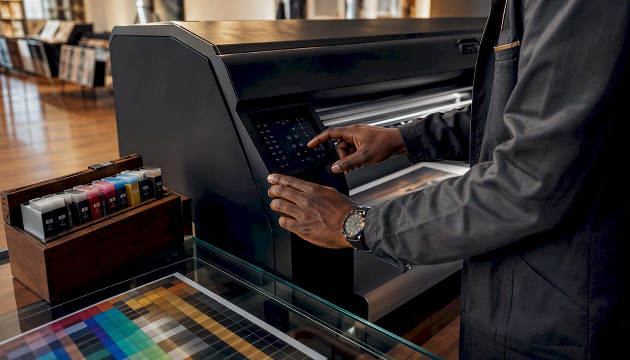 Hands adjusting settings on giclée printer