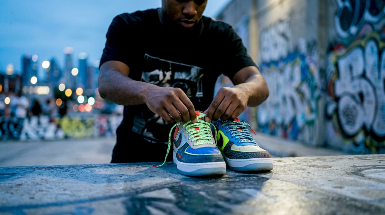 Hands unlacing Adidas Samba sneakers indoors
