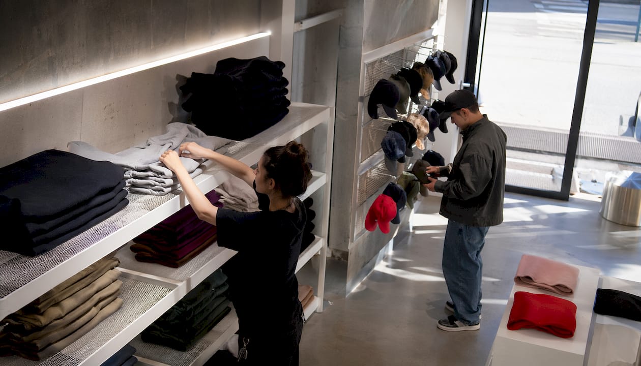 Inside Supreme store with employee and customer