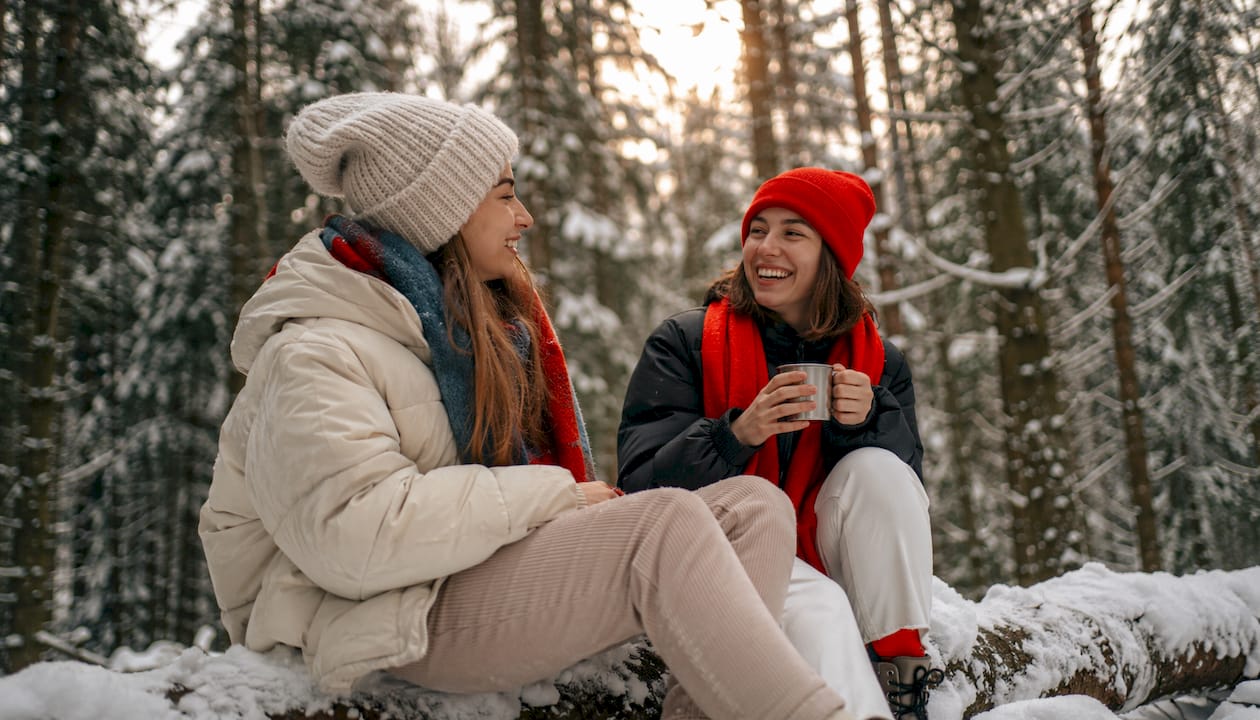 Group wearing beanies in snowy park