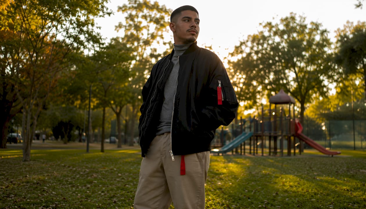 Man wearing oversized denim jacket outdoors in city