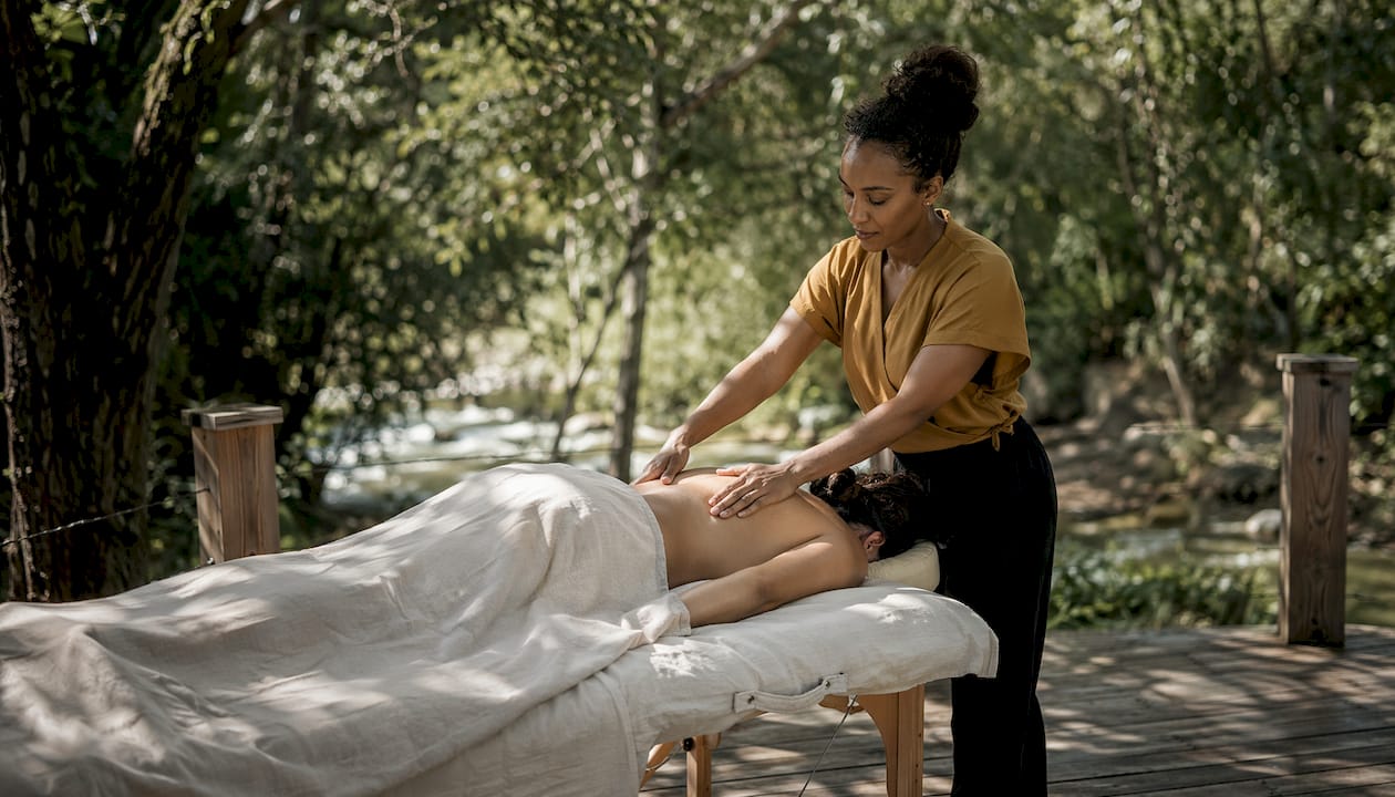 Therapist performing Swedish massage on lower back