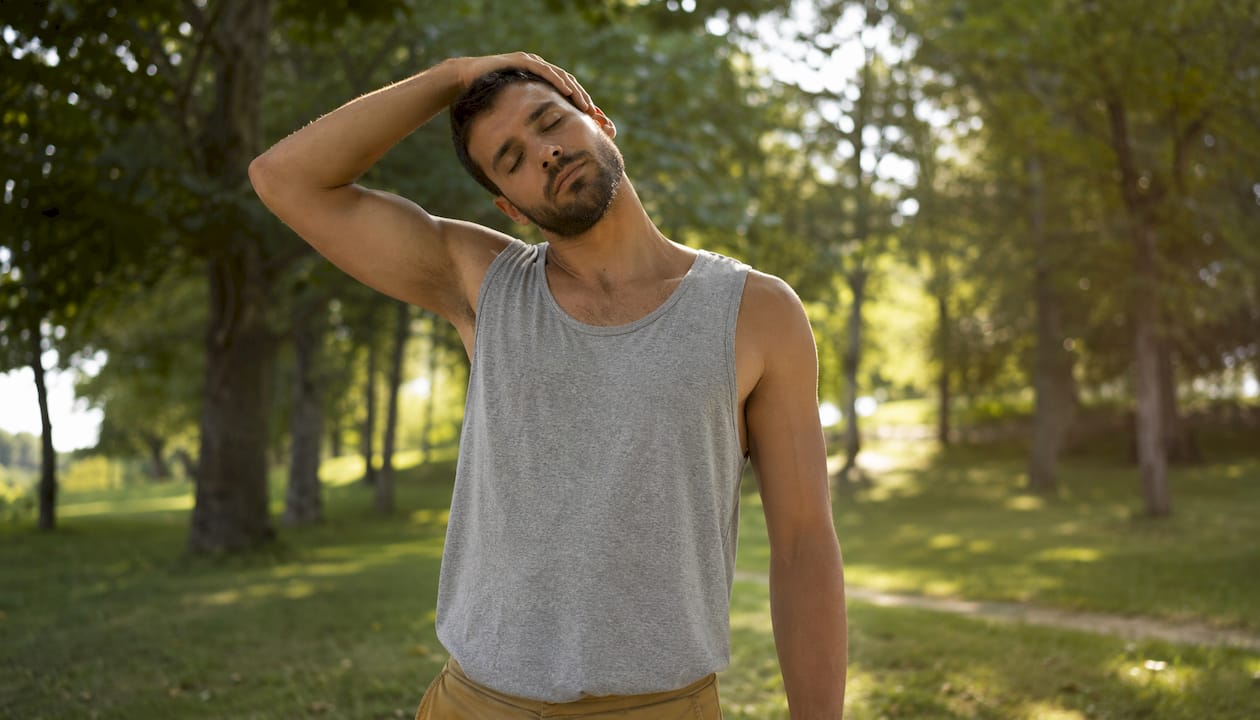 Man performing lateral neck stretch in clinic