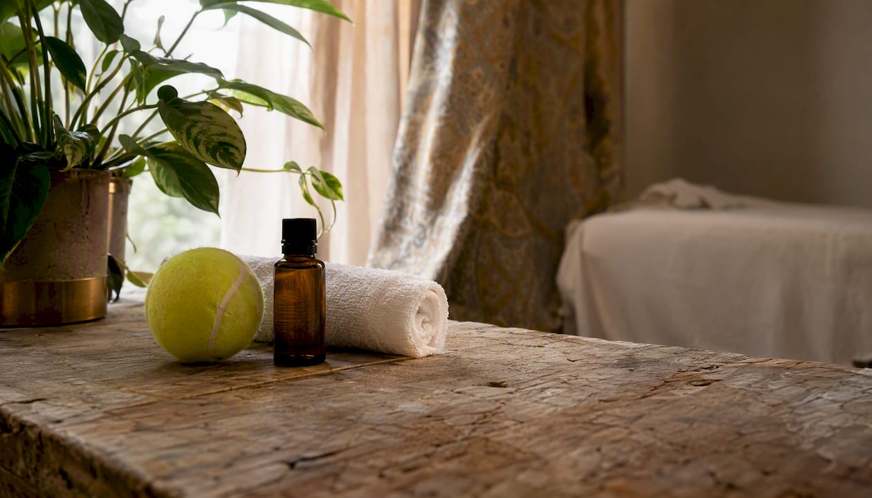 Massage tools essential oils on wooden table