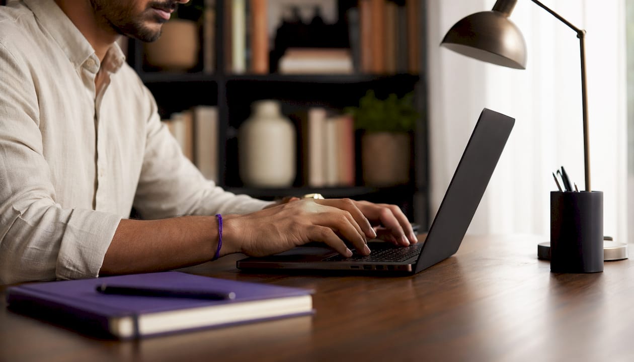 Man typing on laptop in coworking space