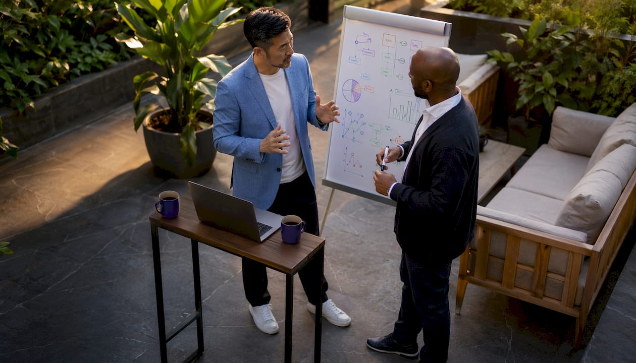 Two men discussing Amazon seller tool strategies