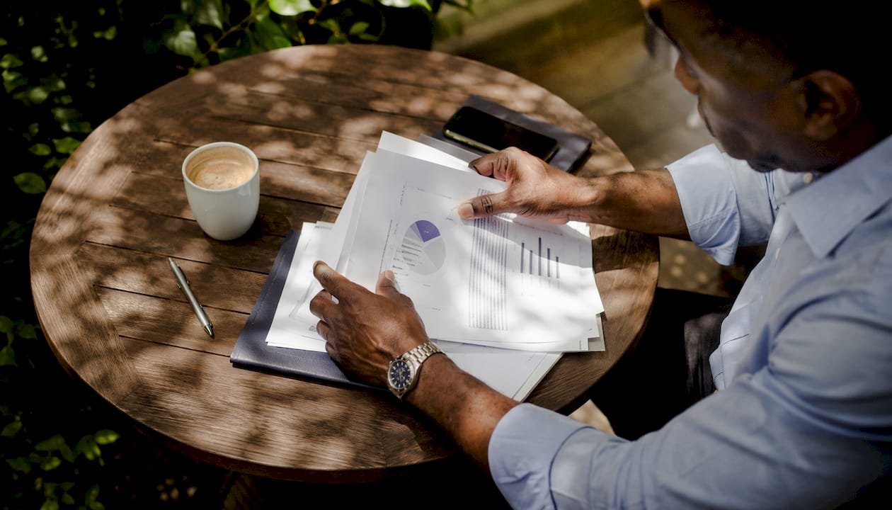 Hands reviewing pricing and features documents