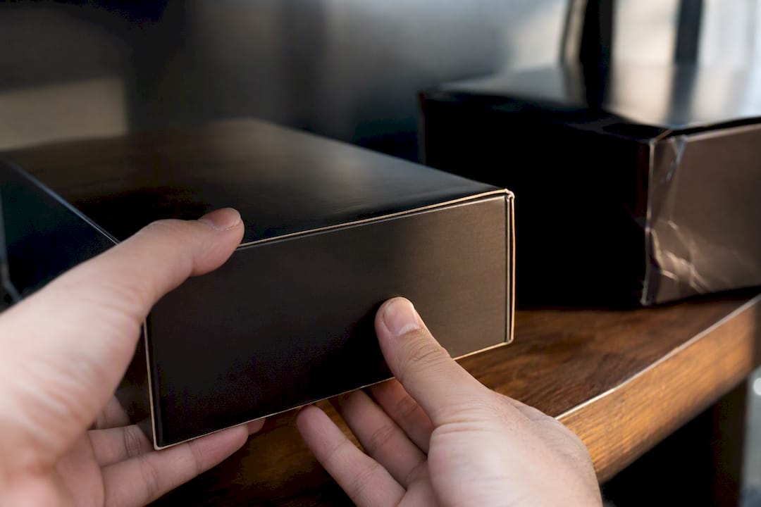 Hands inspecting collector set box condition