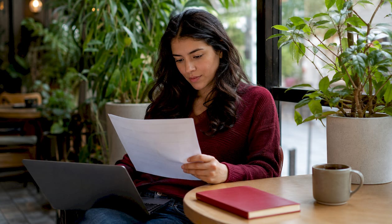 Woman reviewing class action notice at co-working space