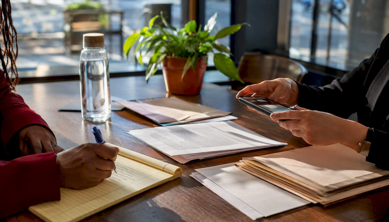 Hands documenting evidence for legal claim