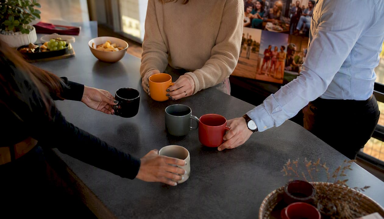 Hands placing headphones on desks symbolizing language diversity