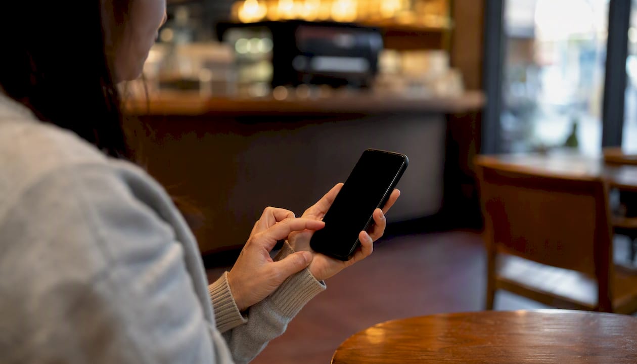 Hands typing follow-up message on smartphone