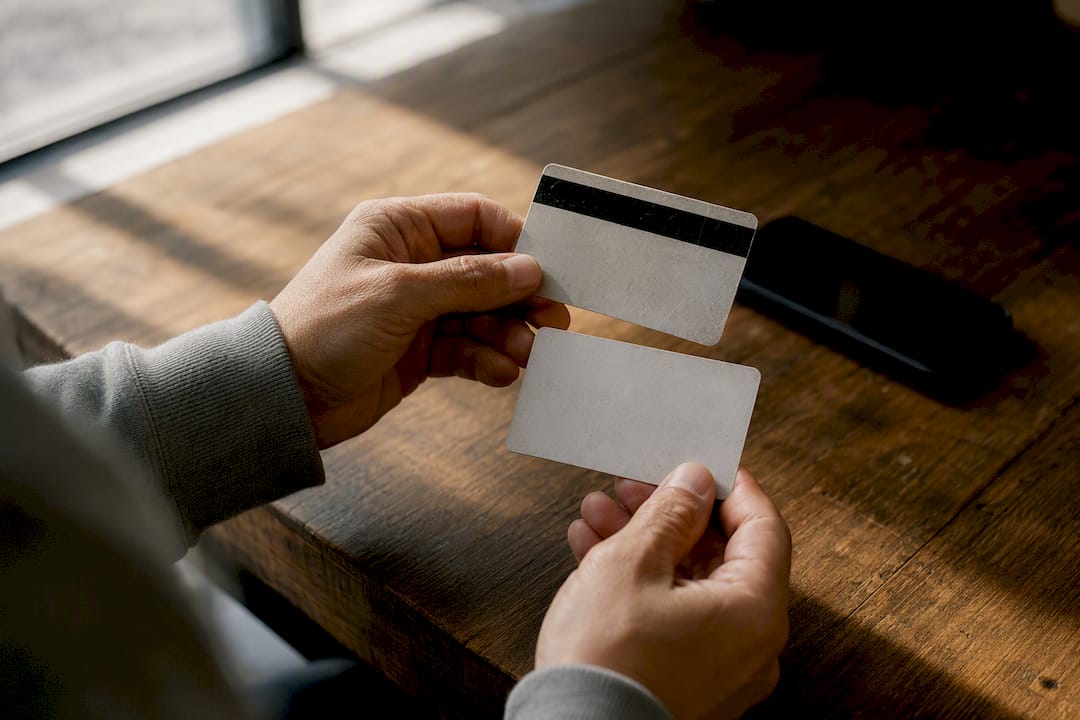 Hand photographing front and back of gift card