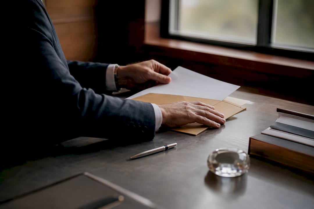 Hands handling class action settlement documents
