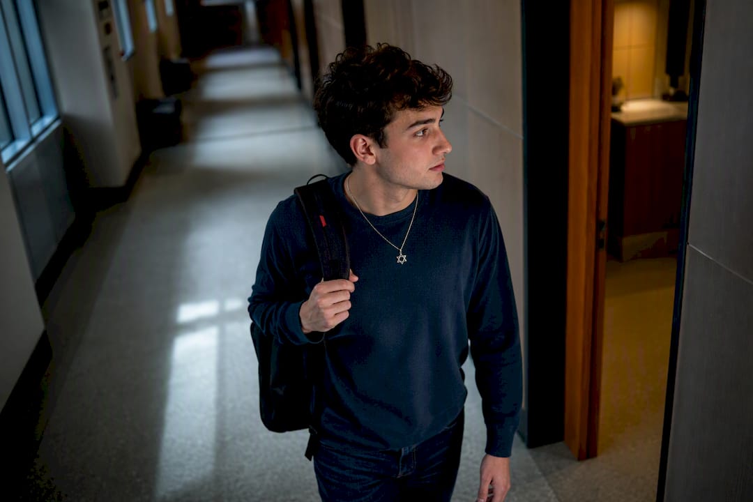 Jewish student walking through campus corridor