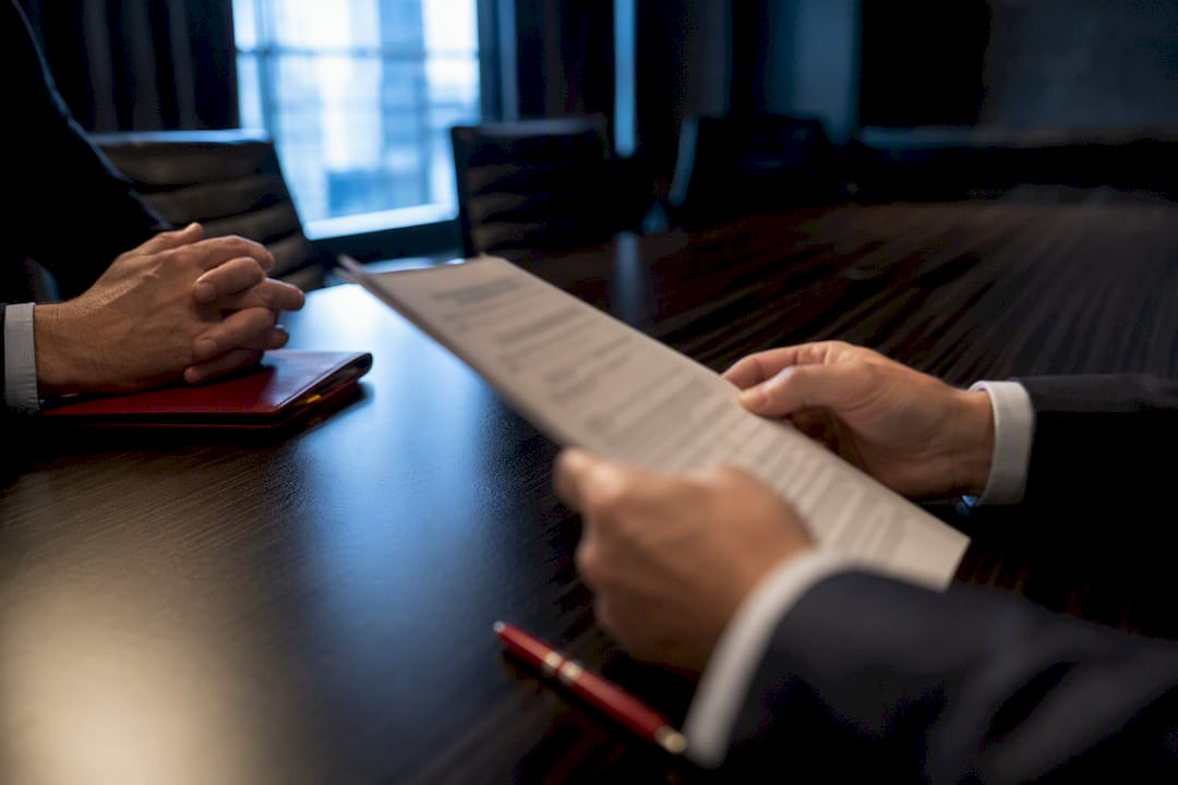 Hands reviewing an arbitration agreement
