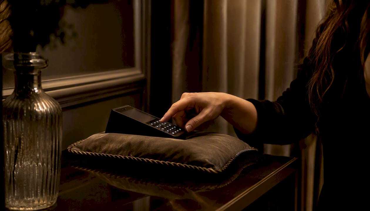 Hand entering PIN on secure device keypad