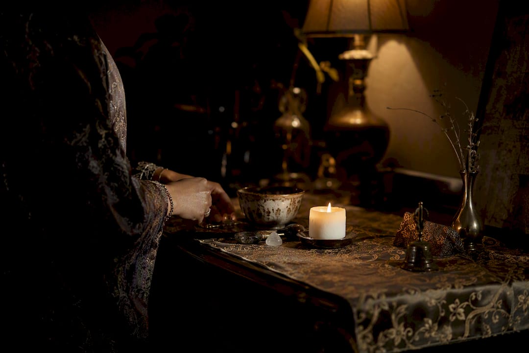 Hand adjusting rituals setup on altar