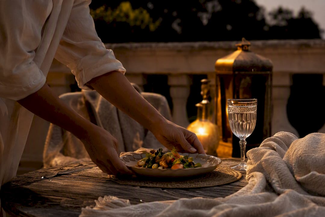 Hands setting water and meal to prepare