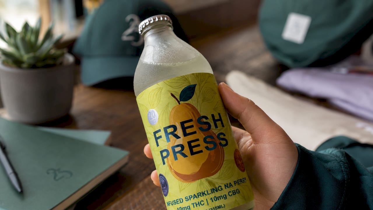 Hand inspecting hemp beverage label closely