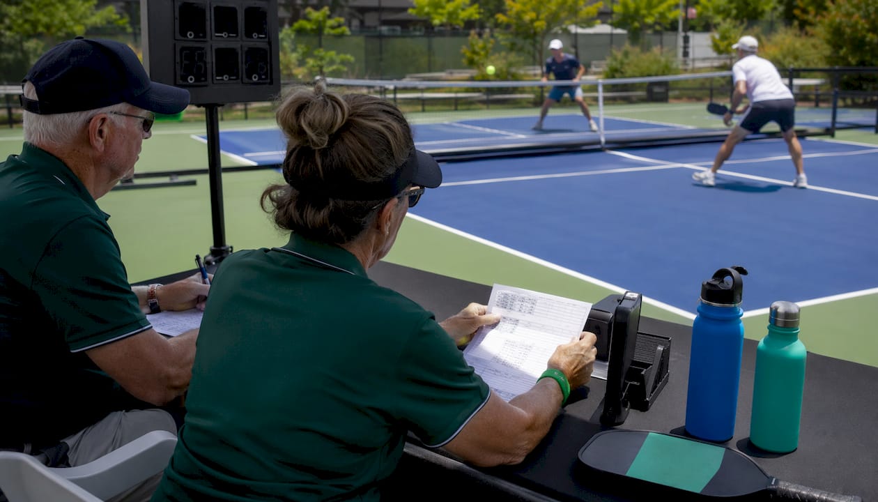 Certified referees managing a pickleball match