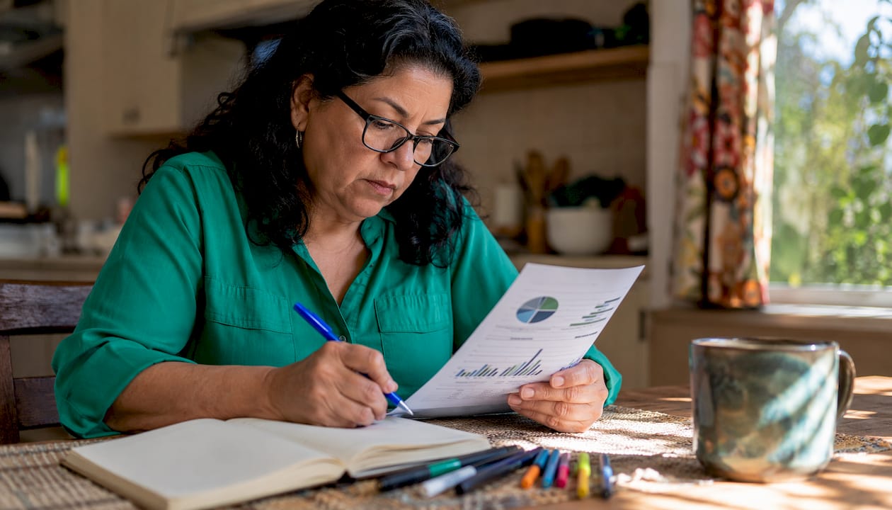 Woman reviewing pickleball growth report at desk