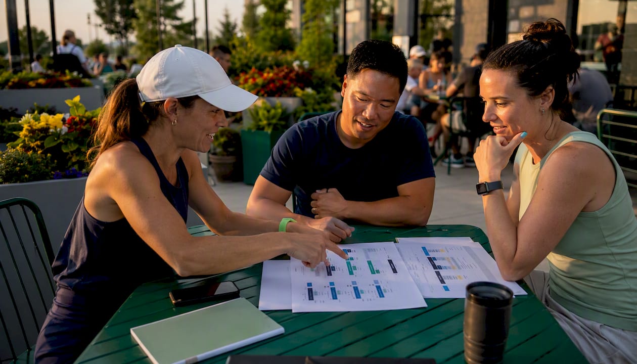 Team reviewing club software comparison charts