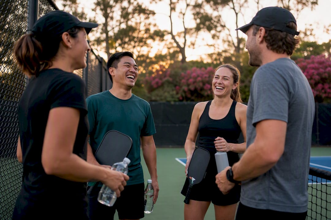 Team members socializing after pickleball match